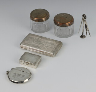 An 800 standard engraved pill box 7.5cm, a vesta, pill box and pipe tamper together with 2 plated mounted jars, weighable silver 78 grams 