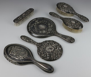 A repousse silver hand mirror Birmingham 1976, 2 hair brushes, a clothes brush and 2 other mirrors 