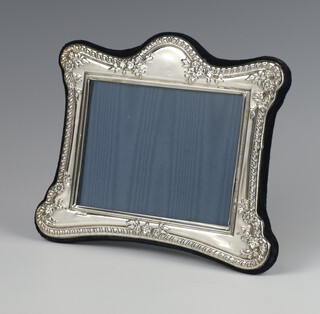 A modern repousse silver photograph frame 13cm x 17cm 