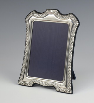 A modern repousse silver photograph frame 18cm x 13cm 