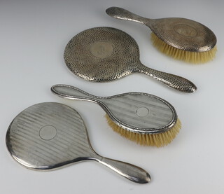 An Art Deco silver backed hand mirror, 1 other, 2 hair brushes 