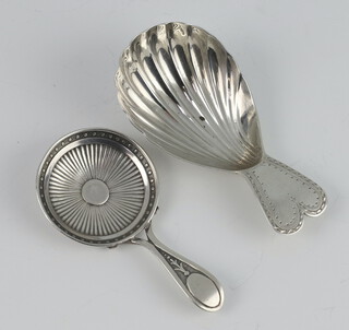 A George III silver caddy spoon Birmingham 1807, a later ditto 
