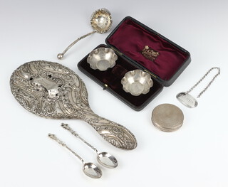 A pair of cased silver salts Birmingham 1924, a sherry label, 2 silver spoons, plated sifter spoon and an engine turned compact, weighable silver 63 grams, together with a holed repousse silver hand mirror  