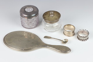 A silver mounted, tortoiseshell and mother of pearl jar Birmingham 1923, a silver backed hand mirror, mustard spoon and napkin ring, 2 other items 