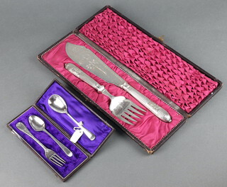 A silver mustard spoon, a cased spoon and fork and a pair of plated fish servers cased 