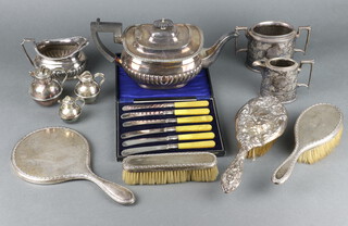 An Edwardian silver backed dressing table set comprising hand mirror, clothes brush, hairbrush, 1 other brush and minor plated wares 