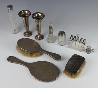 A silver 5 bar toast rack Birmingham 1957, 60 grams, 2 tapered silver posy vases, 4 silver mounted toilet jars, a 3 piece silver backed brush set 