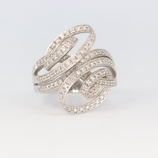 A stylish 18ct white gold whorl diamond set cocktail ring, 11.8 grams, size U 