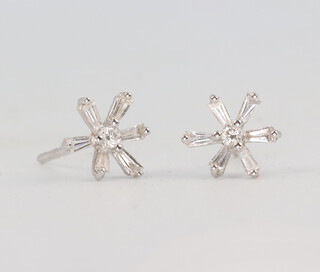 A pair of white metal 750 tapered and brilliant cut baguette floral ear studs 1.2 grams 