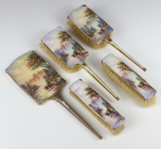 An Art Deco 5 piece dressing table set comprising hand mirror, two clothes brushes and two hair brushes with enamelled scenes of a riverscape with figures in a boat  