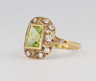 A yellow metal peridot and diamond ring, the centre stone 1.5ct, the diamonds 0.40ct, 3 grams, size N 
