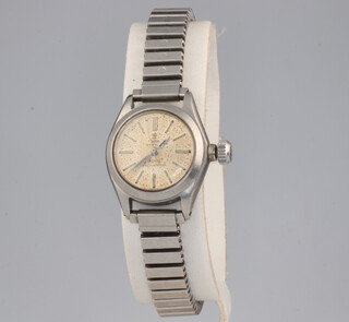 A lady's steel cased Tudor Oyster Royal wristwatch on an expanding steel bracelet with a Rolex guarantee dated 1964, contained in a 21mm case 