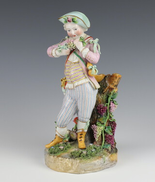 An early 20th Century Meissen figure of a standing youth beside a grapevine 13cm 