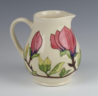 A modern Moorcroft cream ground baluster jug decorated with flowers 14cm 