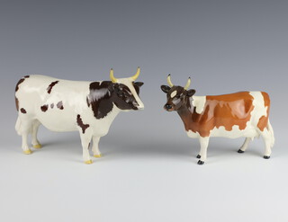 A Beswick figure "Ayrshire Bull, White Hill Mandate" no.1454B, designed by Colin Melbourne, gloss 13.3cm (horns have been restored), a ditto no.1350 "Ayrshire Cow Ickham Bessie" by Arthur Gredington, gloss 12.7cm (restored horns) 