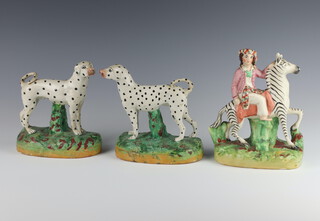 A pair of 19th Century Staffordshire figures of Dalmatians 17cm (stuck and a/f), a ditto of a figure riding a zebra 18cm 