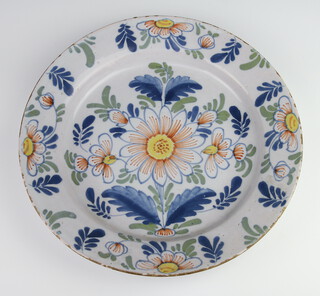 An 18th Century English polychrome Delft shallow bowl decorated with stylised flowers 33cm 