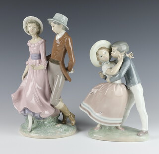 A Lladro group of a embracing young couple 24cm, a Nao ditto of a gentleman and lady 30cm 