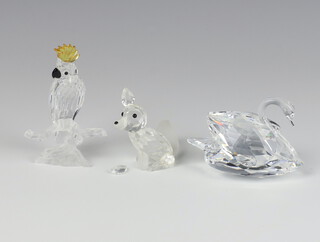 A Swarovski Crystal figure Cockatoo by Heinz Tabertshofer 7621000007 8cm, a ditto of a swan by Max Schreck 7633063000 6cm and a fox by Adi Stocker 7629070000 6cm, all boxed 