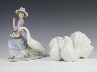 A Lladro figure of a girl with goose 5034 23cm together with a pair of doves 12cm 