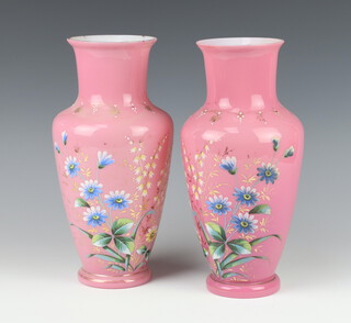A pair of Victorian painted pink glass vases decorated with flowers 29cm 