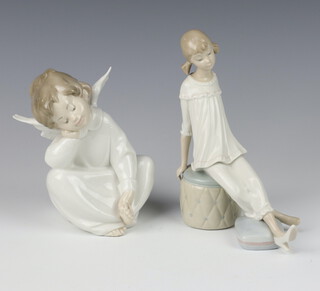 A Lladro figure of a seated angel 17cm, ditto of a girl sitting on a pouffe 19cm 