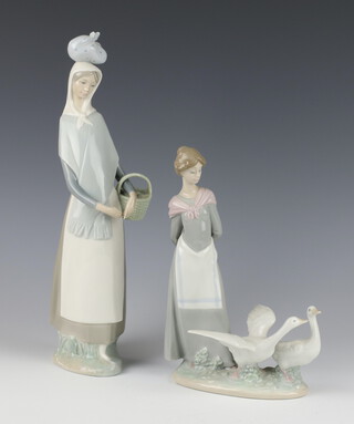 A Lladro figure of a girl with 2 geese 5659 25cm, a ditto of a lady with a basket and a bundle on her head 34cm 