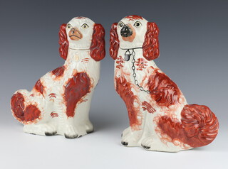 A near pair of Victorian Staffordshire Spaniels with ochre decoration, gilt and black collars 29cm 