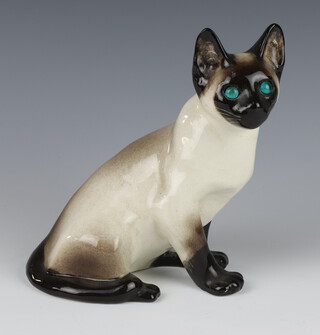 A Jenny Winstanley ceramic figure of a seated Siamese cat with glass eyes no36. 21cm, signed 