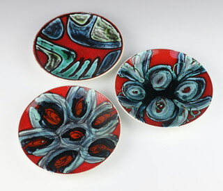 Three Poole red ground dishes with stylised decoration 19cm 
