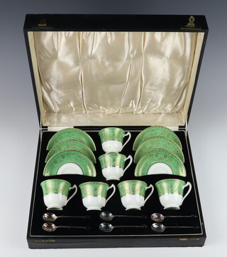 A cased set of 6 Crescent China tea cups and saucers with 6 plated bean end coffee spoons 