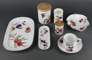 A set of Royal Worcester Evesham dinner, tea and coffee ware comprising 6 coffee cups, 5 mugs, 4 saucers, 8 lidded storage jars, 2 large lidded storage jars, spill vase, butter dish and cover, teapot (no lid), sauce boat stand, 2 shaped dishes, 3 oval dishes, 1 deep bowl, casserole and cover, a deep dish, 2 bowls and 6 teaspoons 
