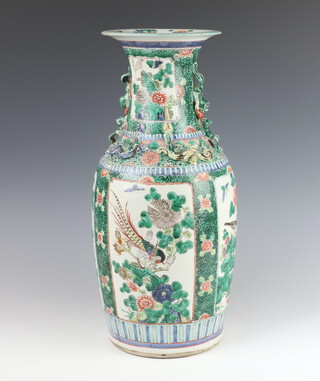 A 19th Century Chinese famille verte oviform vase decorated with panels of exotic birds and flowers with stylised dragon handles 44cm 