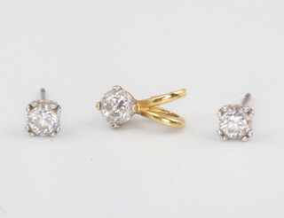 An 18ct yellow gold single stone diamond pendant 0.05ct together with a pair of 18ct white gold ear studs each 0.25ct 