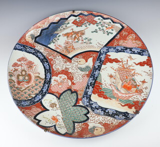 An impressive 19th Century Imari shallow charger decorated with panels of birds and flower 