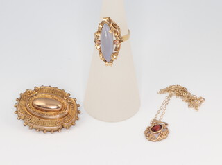 A yellow metal 585 hardstone set ring, a Victorian etruscan style brooch and a garnet pendant 