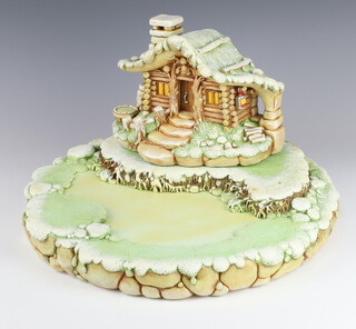 A Pendelfin stepped display stand depicting Christmas Cabin and Lake 40cm 