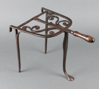 A 19th Century wrought steel, arch shaped range trivet with turned wooden handle 27cm x 40cm x 24cm 