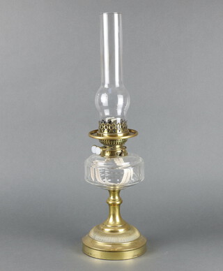 A Victorian panel cut glass oil lamp reservoir with brass fittings marked Evered and Co. complete with chimney 56cm x 15cm 