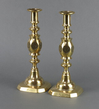 A pair of Victorian brass candlesticks with bullseye decoration, complete with ejectors, the bases marked Good Luck 29cm h x 11cm x 11cm 