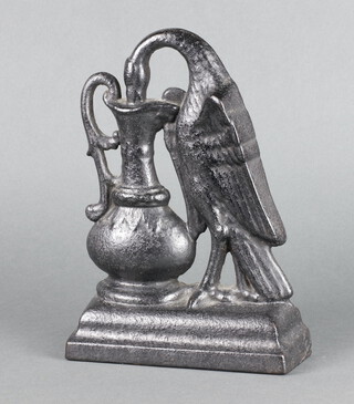 A Victorian cast iron door stop in the form of a bird drinking from a ewer, raised on a shaped base 27cm x 19cm x 7cm 