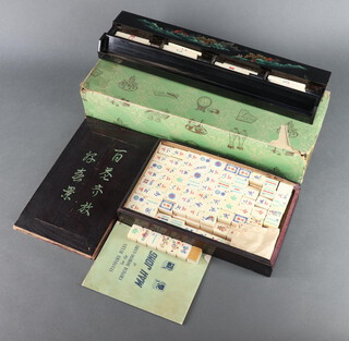 A 152 piece bone and bamboo mahjong set contained in a pine box with sliding lid, together with 4 lacquered counter walls, containing bone counters 