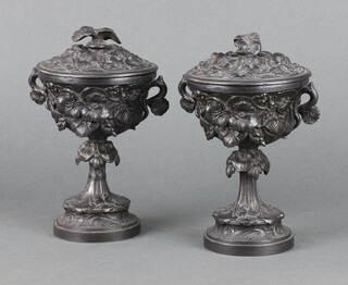 A pair of Victorian spelter lidded twin handled urns with leaf decoration, raised on circular spreading feet 15cm x 8cm 