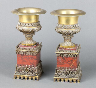 A pair of Victorian gilt bronze urns raised on pink hardstone bases 26cm h x 13cm 