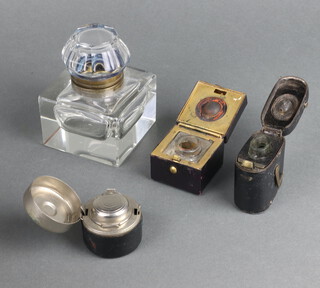 A Victorian square glass inkwell with hinged lid 5cm x 7cm x 7cm, a Victorian square leather covered travelling inkwell 4cm x 4.5cm x 4cm, a cylindrical ditto 4cm x 4cm, an oval ditto 6cm x 5cm x 5cm 