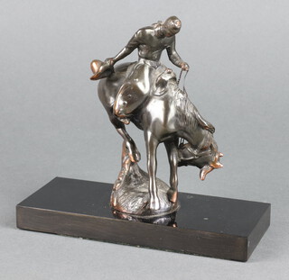 After Remington, a gilt metal figure of a mounted cowboy, raised on a rectangular marble base 18cm h x 18cm w  7cm d 