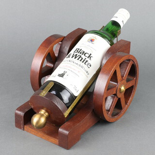 A 75cl bottle of Black & White special blend of Buchanan's Choice Old Scotch Whisky contained in a gun carriage carrier  