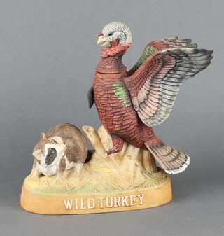 Austin.Nichols and Sons Company Wild Turkey 101 proof bourbon, a limited edition porcelain Wild Turkey and Racoon no.5 1984 decanter (some leakage and turkey's leg a/f)