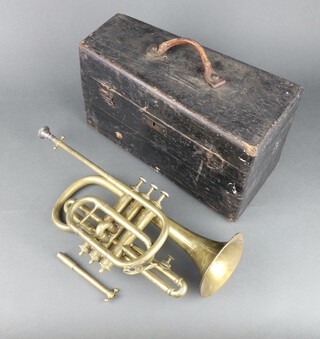A brass cornet the bell marked Glancroix complete with mouthpiece contained in a domed box 