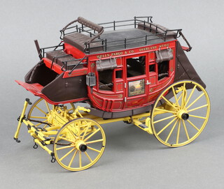 A Franklin Mint model of a Wells Fargo overland stagecoach 17cm h x 27cm w x 11cm d, boxed and with accessories 